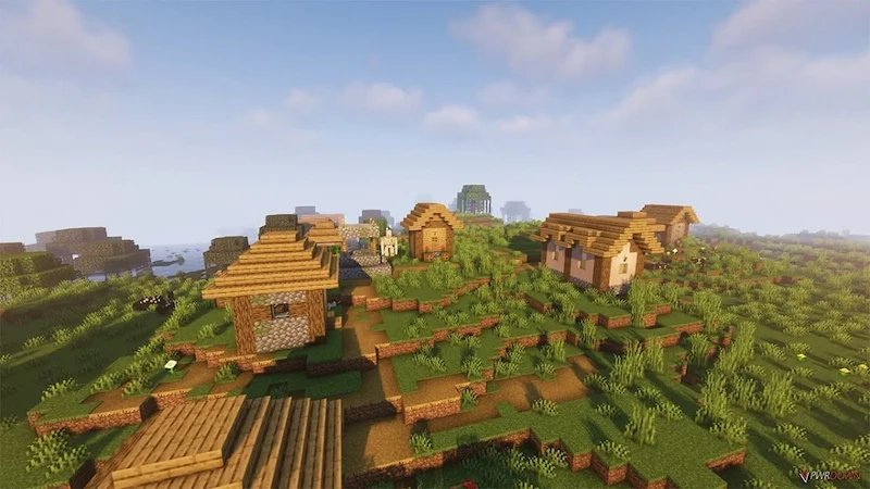 Varias casas de aldeanos en una llanura en Minecraft junto a un río